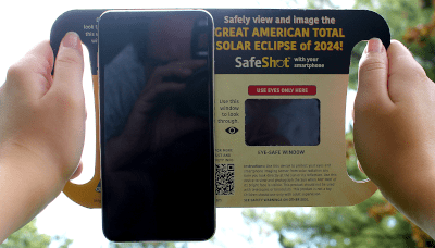 Holding the Safeshot smartphone solar eclipse viewer.